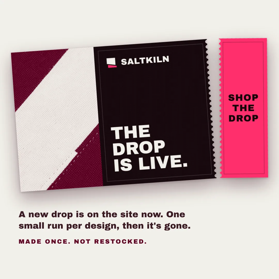 A SALTKILN ad showing a black garment tag that says The drop is live with a pink tear-off stub marked Shop the drop.